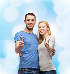 Image showing smiling couple showing thumbs up