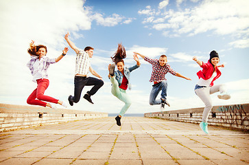 Image showing group of teenagers jumping