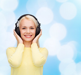 Image showing smiling young woman with headphones