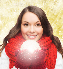 Image showing smiling woman in winter clothes with snowball