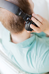 Image showing close up of man in headphones at home