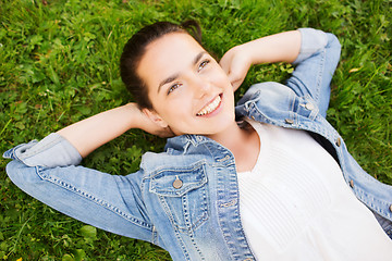 Image showing smiling young girl lying on grass