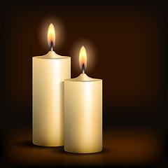 Image showing Two burning candles on black background.
