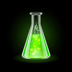 Image showing Transparent flask with magic green liquid on black background.