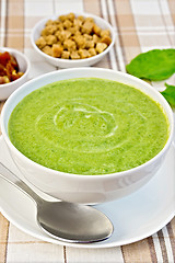 Image showing Soup puree with spinach and croutons on fabric