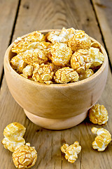 Image showing Popcorn caramel in wooden bowl on board