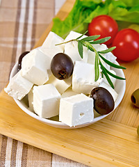 Image showing Feta with olives and tomato on brown cloth