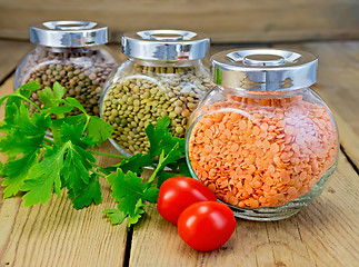 Image showing Lentils different in jars with parsley on board