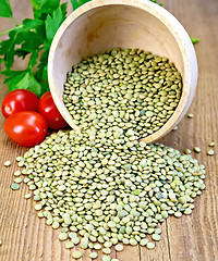 Image showing Lentils green in bowl with tomatoes on board