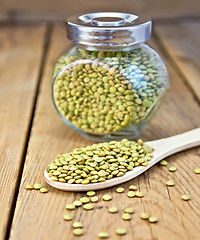 Image showing Lentils green in jar and spoon on board