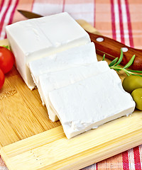 Image showing Feta with olives and tomatoes on a red fabric