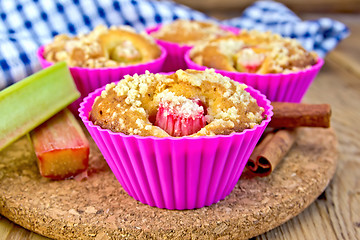 Image showing Cupcakes with rhubarb in tins on board