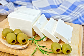 Image showing Feta with olives and rosemary on board with blue cloth