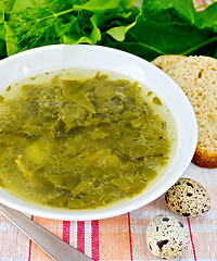 Image showing Soup of greenery on fabric with bread