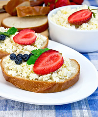 Image showing Bread with curd and berries on blue cloth