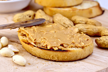 Image showing Sandwich with peanut butter and knife on board