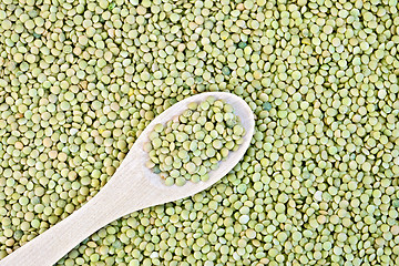 Image showing Lentils green texture with a wooden spoon