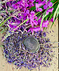 Image showing Herbal tea with strainer of fireweed on board