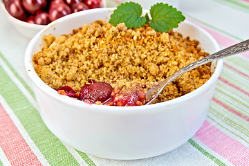 Image showing Crumble cherry with berries on napkin