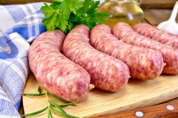 Image showing Sausages pork with rosemary on board