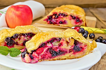 Image showing Strudel with black currants and apples on board