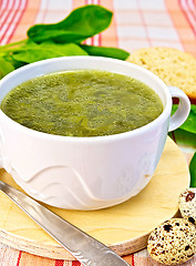 Image showing Soup of greenery on fabric with quail eggs