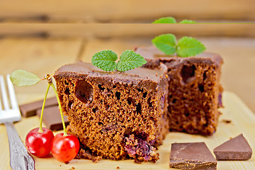 Image showing Cake chocolate with cherries on board