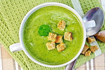 Image showing Soup puree with crackers and spoon on napkin