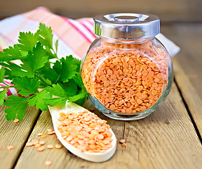 Image showing Lentils red in jar and spoon with parsley on board