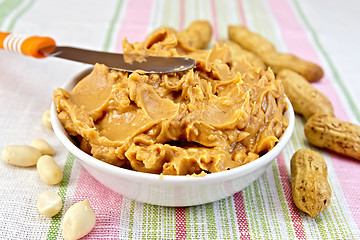 Image showing Butter peanut with a knife on tablecloth