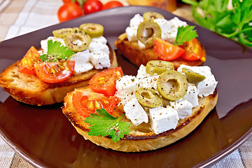 Image showing Sandwich with feta and olives on tablecloth