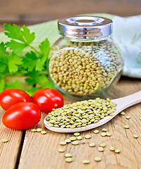 Image showing Lentils green in jar and spoon with tomatoes on board