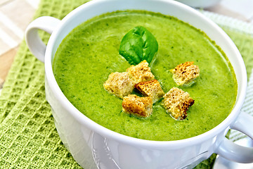 Image showing Soup puree with croutons and spinach on napkin