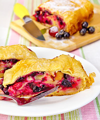 Image showing Strudel with black currants on the tablecloth