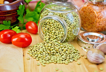 Image showing Lentils green in jar with garlic on board