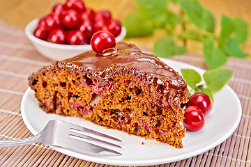 Image showing Cake chocolate with cherries on bamboo napkin