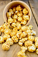 Image showing Popcorn caramel on board in wooden bowl