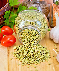 Image showing Lentils green in jar with tomato on board