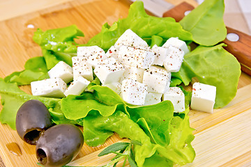 Image showing Feta with lettuce and black olives on board