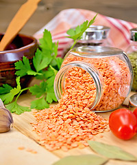 Image showing Lentils red in jar with parsley on board
