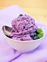 Image showing Ice cream blueberry with spoon on napkin