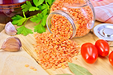 Image showing Lentils red in jar with tomato on board