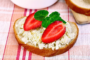 Image showing Bread with curd and strawberries on red napkin