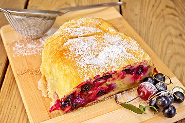 Image showing Strudel with black currants on board