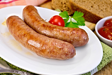 Image showing Sausages pork fried in plate on board