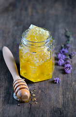 Image showing honeycomb and honey in glass jars 