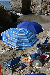 Image showing Blue parasols on hidden beach