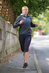 Image showing Pretty young girl runner on the street.