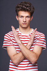 Image showing Young serious man doing stop symbol