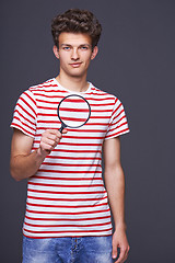 Image showing Man holding magnifying glass